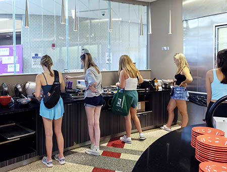 Students at a self serve food counter